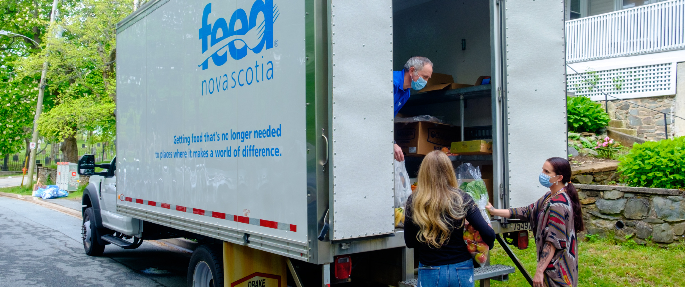 two people receiving food from back of Feed Nova Scotia truck