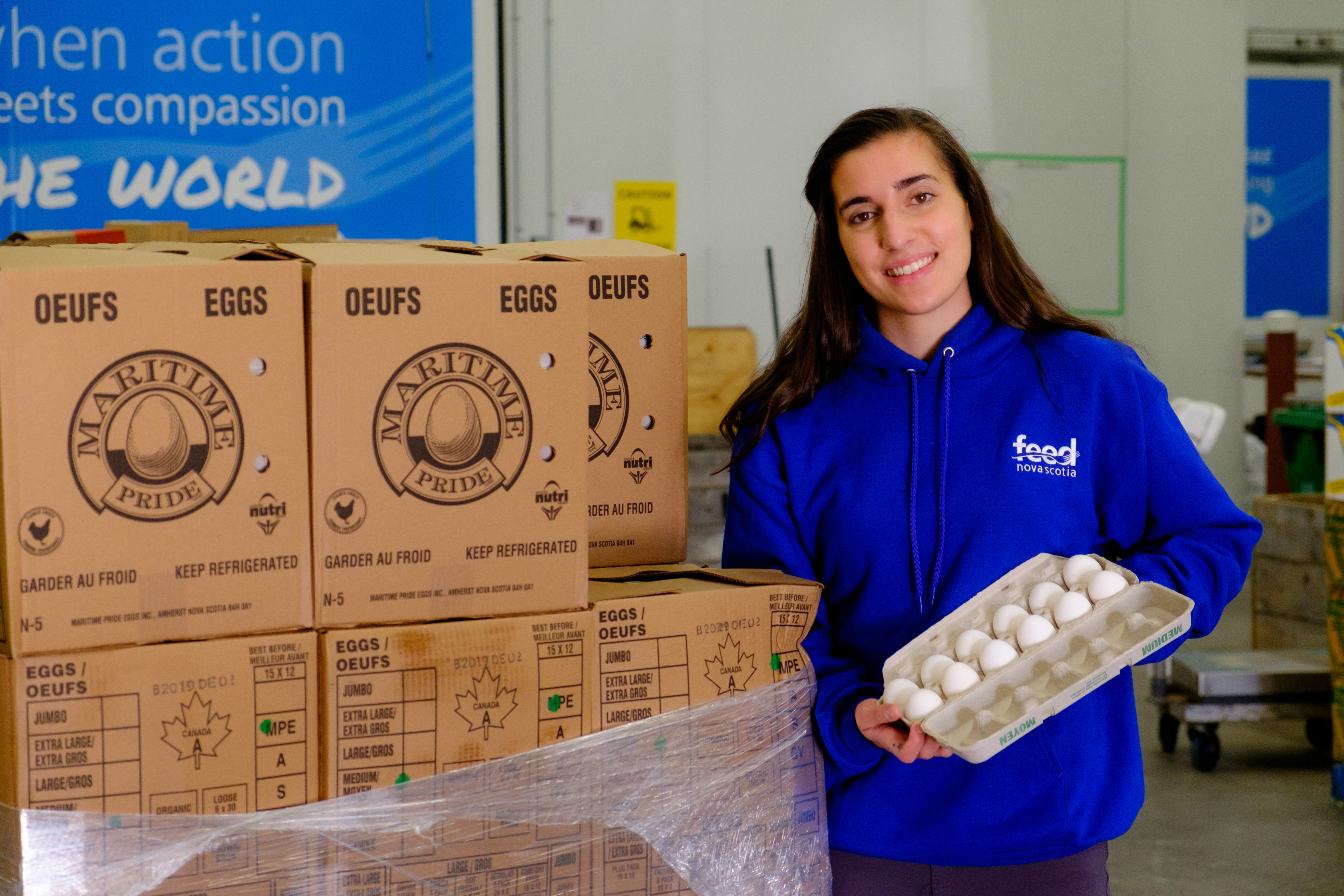 Feed Nova Scotia team member holds a carton of eggs