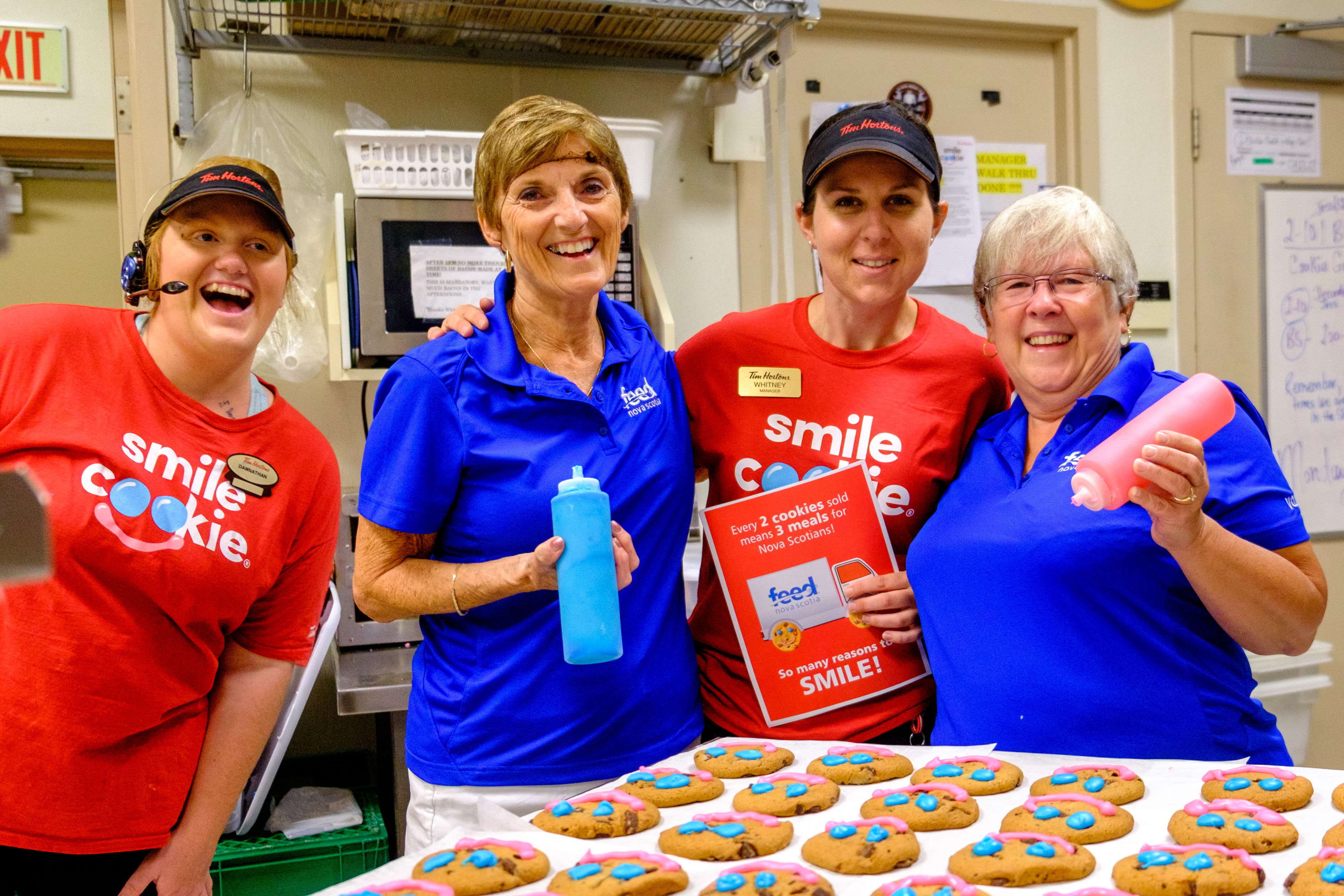 Feed Nova Scotia volunteers and Tim Hortons staff posing with Smile Cookies