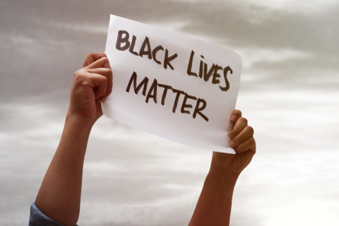 Person holding poster with the words Black Lives Matter