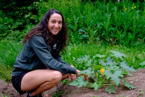 Volunteer kneeling down gardening