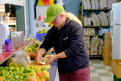 Women cutting food on a counter 