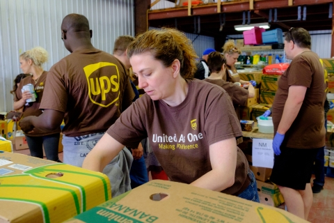 A UPS employee sorts food in the Feed Nova Scotia warehouse