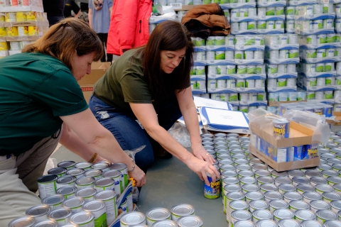 Kent Building Supplies Canstruction team two people using cans to make a sculpture
