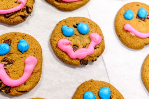 Smile Cookies icing smiles on chocolate chunk cookies