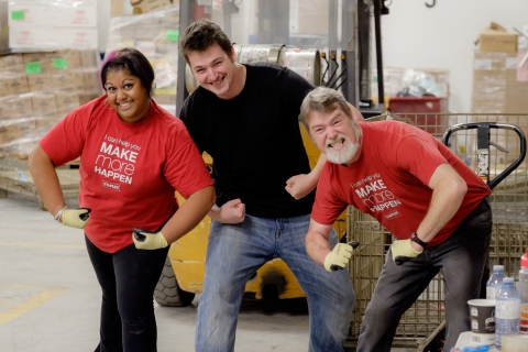 Three volunteers flexing their muscles 