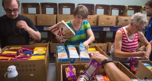 Four people sorting food within Feed Nova Scotia boxes