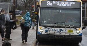 passenger about to board the number nine transit bus to Greystone