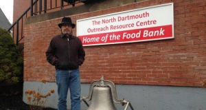 Kevin Clarke, president of North Dartmouth Outreach Resource Centre standing next to the sign outside the centre