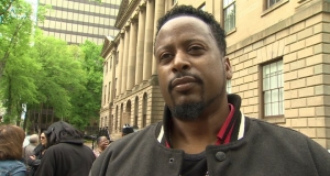 man standing in front of a courthouse looking at the camera