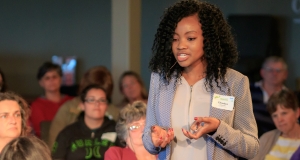 A women speaking in front of a crowd