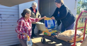 Food bank volunteers receiving a delivery of pet food