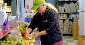 Women cutting food on a counter 