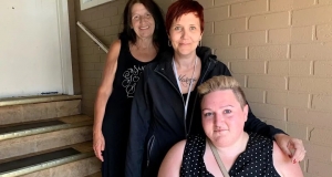 three people sitting on stairs