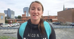 Young woman with a backpack talking into a video camera