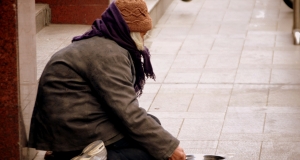 a homeless woman on a city sidewalk 