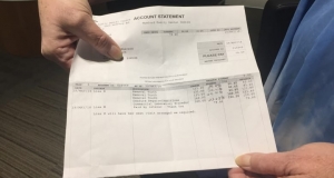 two hands holding an invoice