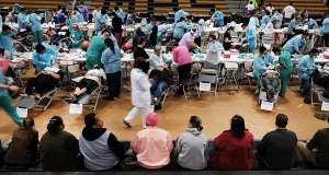 A gymnasium is a makeshift dental office with many patients and dental professionals