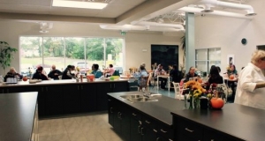 people gathered at tables in the Food Centre