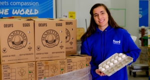 Feed Nova Scotia team member holds a carton of eggs