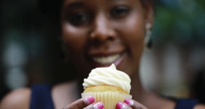 woman holding a cupcake